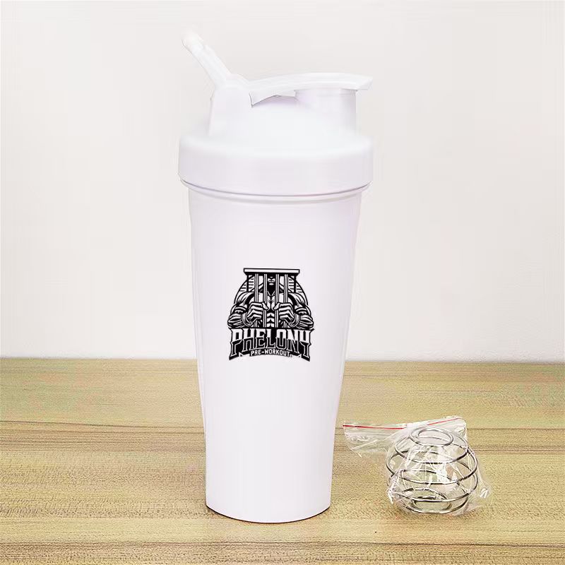 White 600ml shaker cup with the Phelony logo on a wooden surface